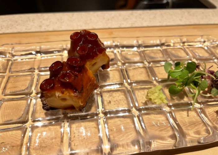 Octopus sushi is being served on a glass serving tray at Gion Sushi Tadayasu, a Michelin star sushi restaurant in Kyoto.